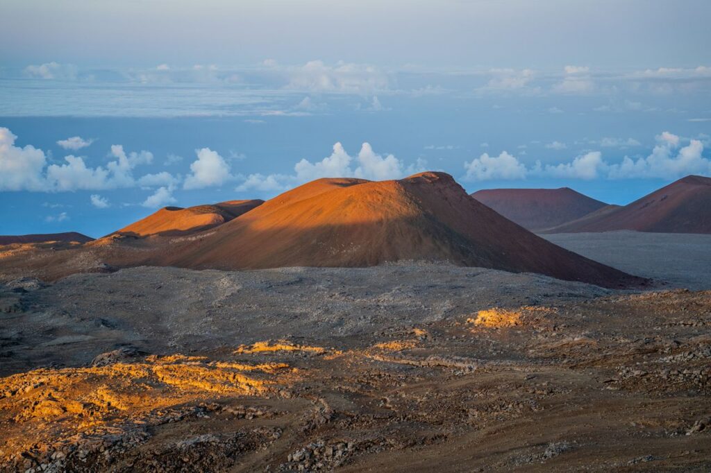 Stunning view of Mauna Kea in Hawaii during sunset, capturing volcanic beauty under a vibrant sky.